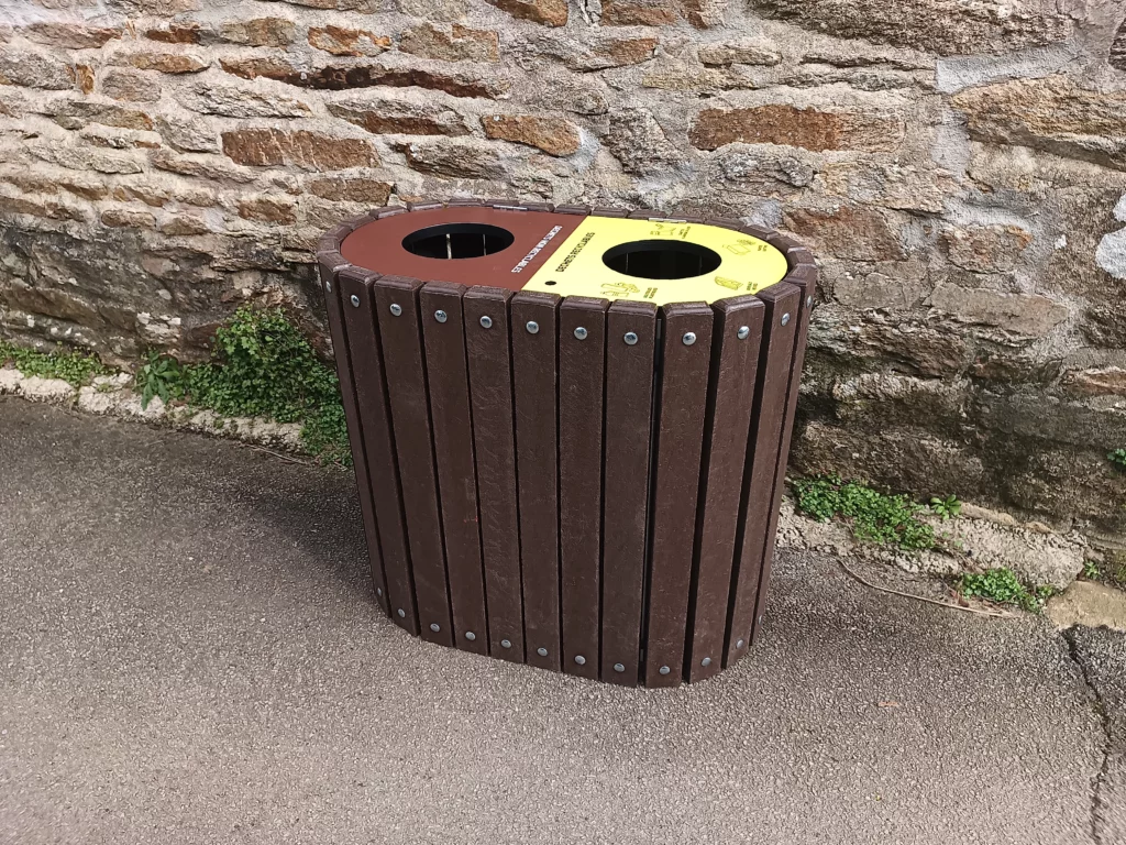 Poubelle biflux ronde installée dans un espace extérieur public ou paysager